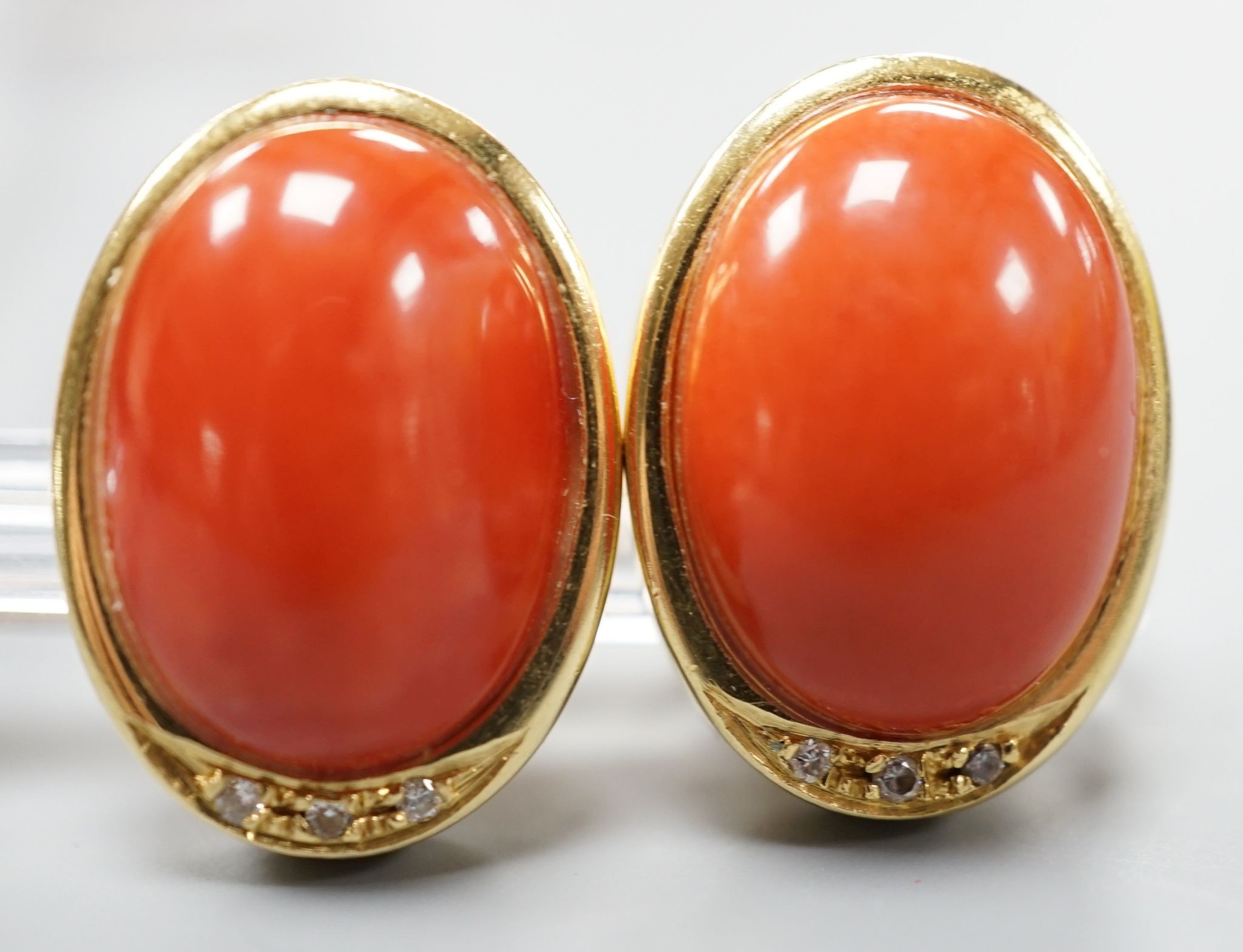 A pair of modern Italian 750 yellow metal a oval coral bead set earrings, 18mm, gross weight 11.7 grams.